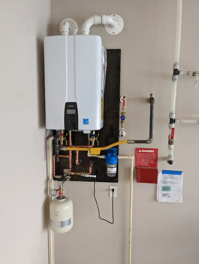 Professional plumber installing copper piping in a South Haven home